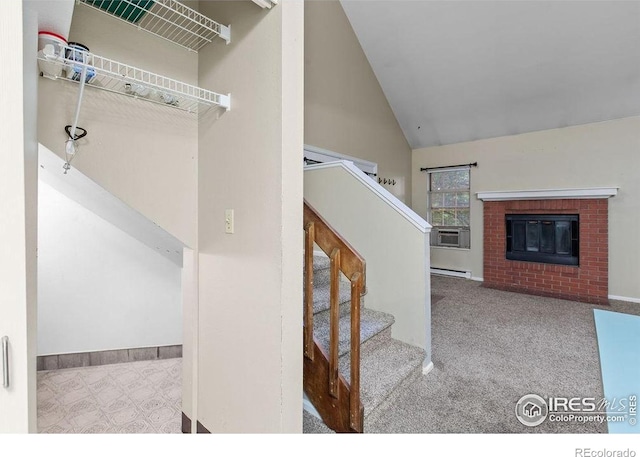 3565 Windmill Dr Unit F-7, Fort Collins, CO 80526 - stairs with a baseboard heating unit, cooling unit, a fireplace, high vaulted ceiling, and carpet floors