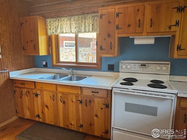 110 Meadow Ln, Bellvue, CO 80512 - kitchen featuring white electric range, light countertops, brown cabinets, and wood finished floors