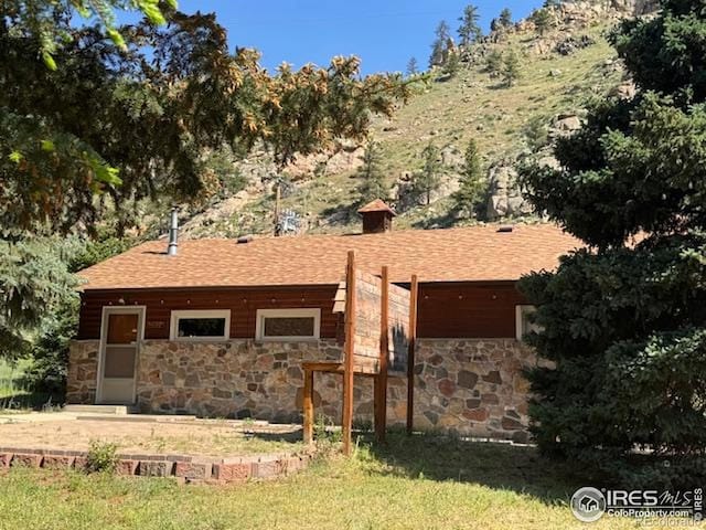 110 Meadow Ln, Bellvue, CO 80512 - ranch-style house with stone siding, a shingled roof, and a front yard