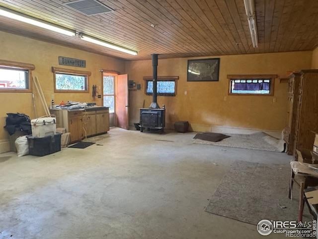 110 Meadow Ln, Bellvue, CO 80512 - garage featuring a wood stove and wooden ceiling