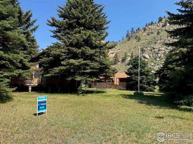 110 Meadow Ln, Bellvue, CO 80512 - view of grassy yard with a deck