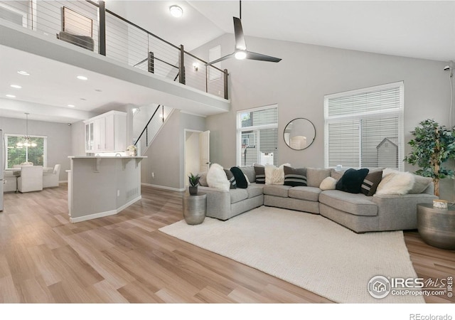 641 Babine Ct, Windsor, CO 80550 - living area with ceiling fan, light wood-style flooring, high vaulted ceiling, a chandelier, and recessed lighting