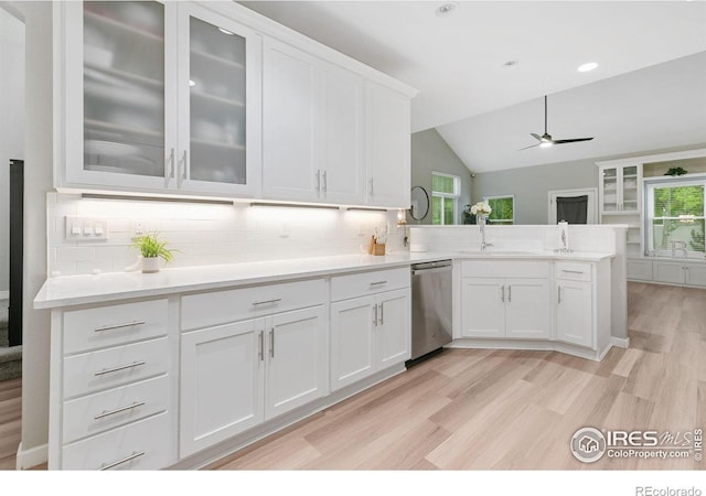 641 Babine Ct, Windsor, CO 80550 - kitchen featuring dishwasher, vaulted ceiling, a ceiling fan, white cabinetry, and a peninsula