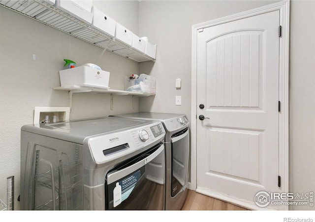 641 Babine Ct, Windsor, CO 80550 - washroom featuring washer and dryer and light wood-style flooring