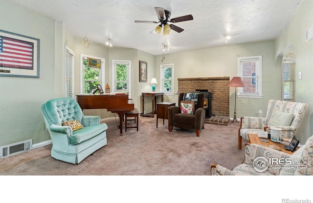 1817 15th Ave, Greeley, CO 80631 - carpeted living room featuring a ceiling fan, a textured ceiling, and arched walkways