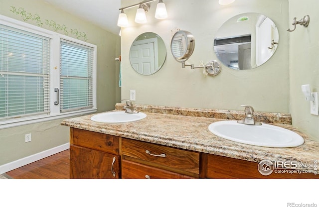 1817 15th Ave, Greeley, CO 80631 - full bathroom featuring double vanity and wood finished floors