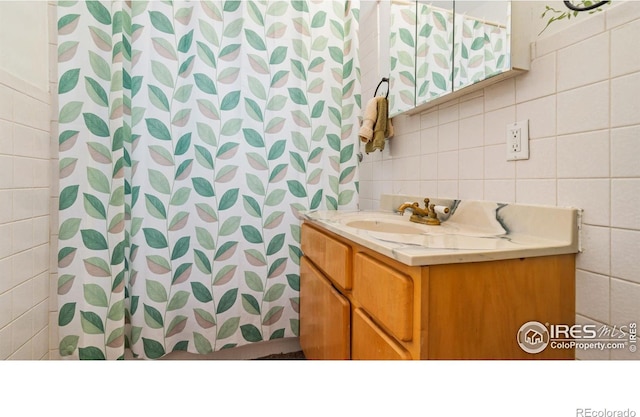 1817 15th Ave, Greeley, CO 80631 - full bathroom with tile walls, vanity, tasteful backsplash, and a shower with shower curtain