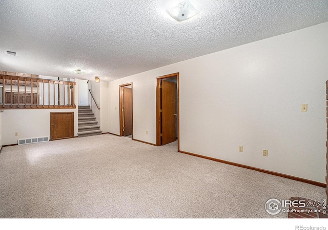 837 Arbor Ave, Fort Collins, CO 80526 - carpeted empty room featuring stairs and a textured ceiling