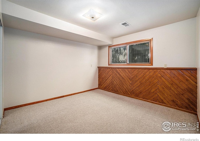 837 Arbor Ave, Fort Collins, CO 80526 - empty room with carpet, a wainscoted wall, and wooden walls