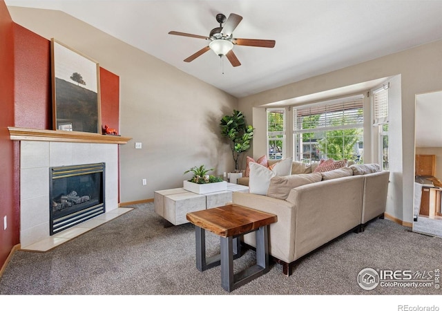 2217 Waylon Dr, Johnstown, CO 80534 - carpeted living room with lofted ceiling, a ceiling fan, and a fireplace
