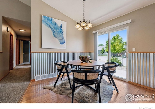 2217 Waylon Dr, Johnstown, CO 80534 - dining area with a chandelier, hardwood / wood-style floors, and vaulted ceiling