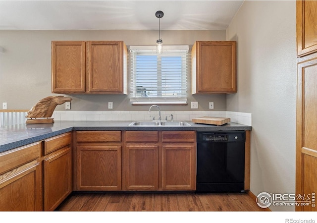 2217 Waylon Dr, Johnstown, CO 80534 - kitchen featuring dishwasher, dark wood-type flooring, pendant lighting, dark countertops, and brown cabinets