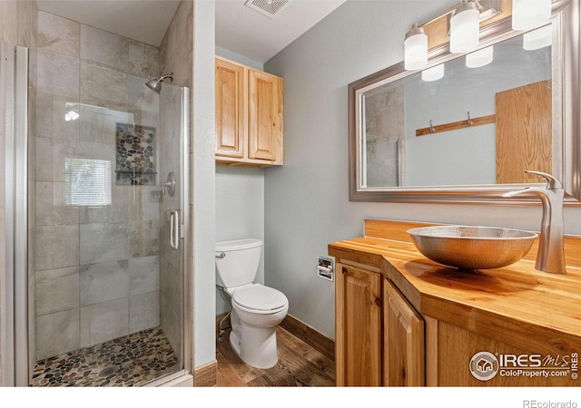 2217 Waylon Dr, Johnstown, CO 80534 - full bathroom with a stall shower, vanity, and wood finished floors