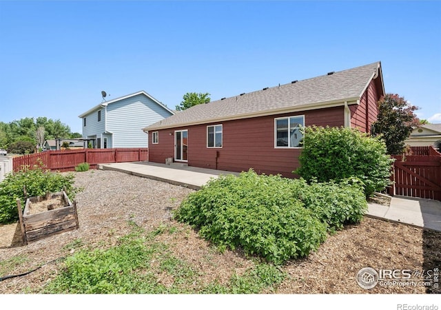 2217 Waylon Dr, Johnstown, CO 80534 - back of house with a patio, a garden, and a shingled roof
