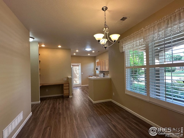 1238 Finch St, Loveland, CO 80537 - kitchen with white appliances, dark wood finished floors, a chandelier, pendant lighting, and recessed lighting