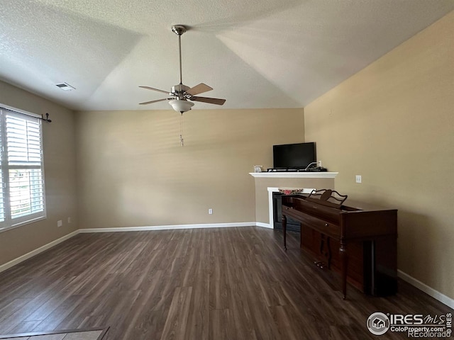 1238 Finch St, Loveland, CO 80537 - living room with ceiling fan, dark wood-style floors, vaulted ceiling, and a textured ceiling