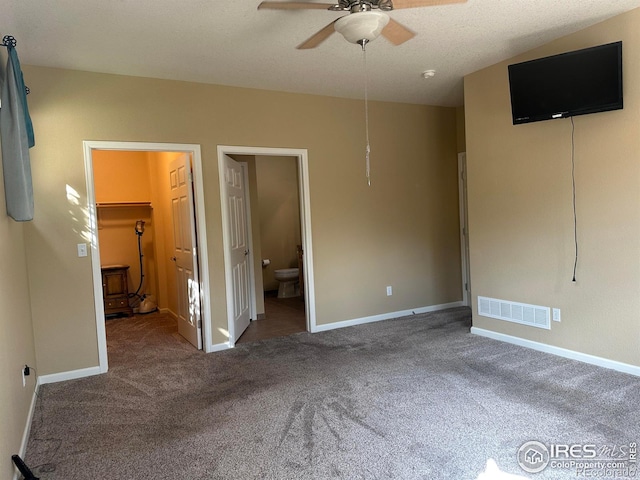1238 Finch St, Loveland, CO 80537 - unfurnished bedroom featuring a walk in closet, carpet, connected bathroom, a ceiling fan, and a closet