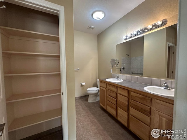 1238 Finch St, Loveland, CO 80537 - full bathroom featuring double vanity, a tile shower, tile patterned floors, and a spacious closet