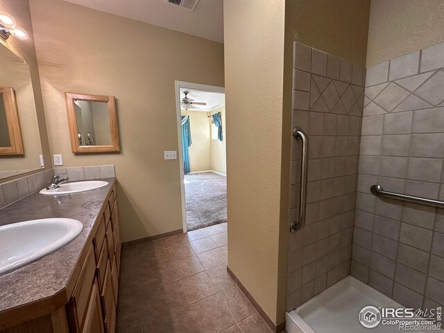 1238 Finch St, Loveland, CO 80537 - full bathroom with double vanity, tile patterned flooring, a tile shower, and a ceiling fan