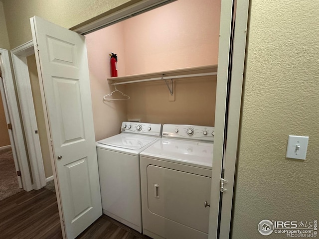 1238 Finch St, Loveland, CO 80537 - washroom featuring washer and clothes dryer, dark wood finished floors, and a textured wall