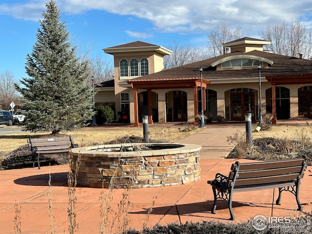 1238 Finch St, Loveland, CO 80537 - back of property featuring a fire pit and stucco siding