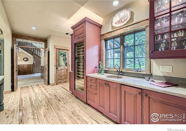8576 Niwot Meadow Farm Rd, Niwot, CO 80503 - bar featuring light wood-style floors, beverage cooler, recessed lighting, and stairway