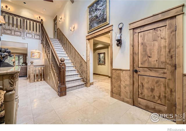 8576 Niwot Meadow Farm Rd, Niwot, CO 80503 - staircase with a towering ceiling and wainscoting