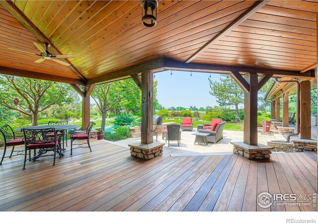 8576 Niwot Meadow Farm Rd, Niwot, CO 80503 - wooden deck with ceiling fan, outdoor dining area, and an outdoor living space