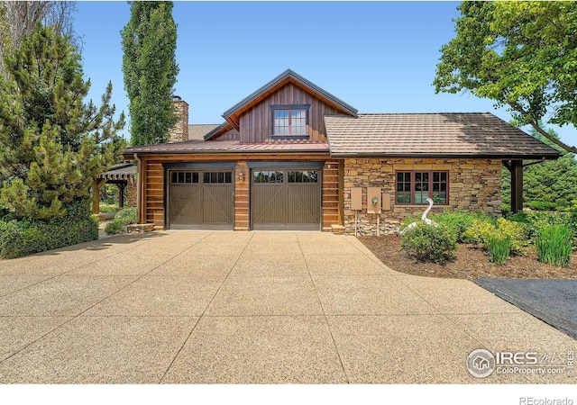 8576 Niwot Meadow Farm Rd, Niwot, CO 80503 - view of front facade with concrete driveway, board and batten siding, stone siding, a chimney, and an attached garage