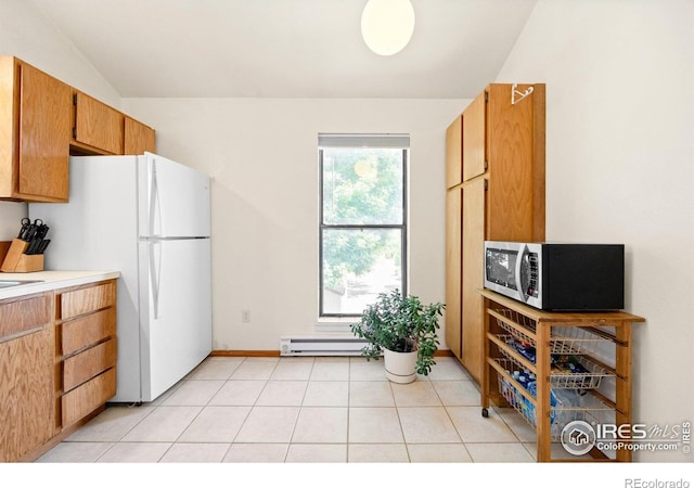 4717 Tantra Dr Unit G, Boulder, CO 80305 - kitchen featuring vaulted ceiling, freestanding refrigerator, light countertops, a baseboard heating unit, and light tile patterned floors