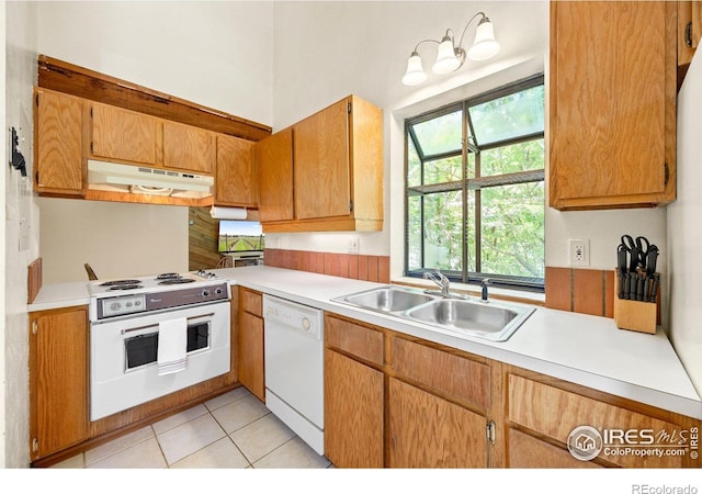 4717 Tantra Dr Unit G, Boulder, CO 80305 - kitchen featuring white appliances, under cabinet range hood, light countertops, and light tile patterned floors