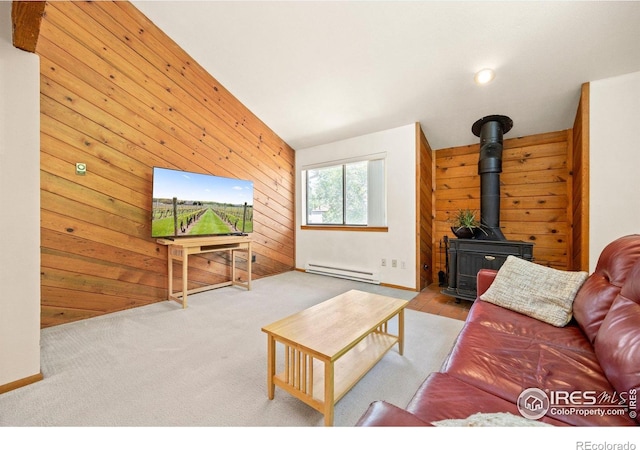 4717 Tantra Dr Unit G, Boulder, CO 80305 - living area featuring a baseboard radiator, a wood stove, and wooden walls
