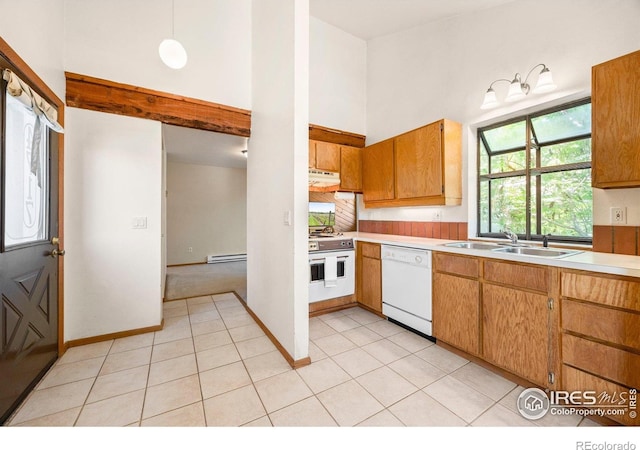 4717 Tantra Dr Unit G, Boulder, CO 80305 - kitchen featuring white appliances, light countertops, baseboard heating, light tile patterned flooring, and under cabinet range hood