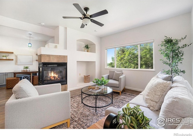702 Cairnes Dr Unit B4, Fort Collins, CO 80524 - living room featuring wood finished floors, a tile fireplace, ceiling fan, and beverage cooler