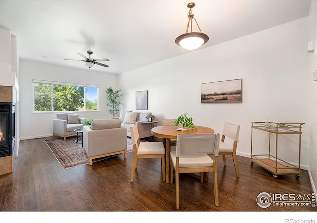 702 Cairnes Dr Unit B4, Fort Collins, CO 80524 - dining room featuring a glass covered fireplace, dark wood-style floors, and a ceiling fan