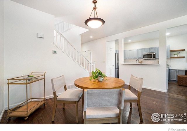 702 Cairnes Dr Unit B4, Fort Collins, CO 80524 - dining space with dark wood-type flooring, stairs, and recessed lighting