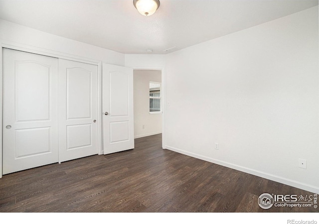 702 Cairnes Dr Unit B4, Fort Collins, CO 80524 - unfurnished bedroom featuring dark wood-style floors and a closet