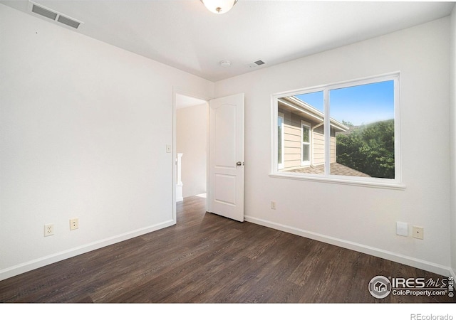 702 Cairnes Dr Unit B4, Fort Collins, CO 80524 - spare room with dark wood-style flooring and a smoke detector