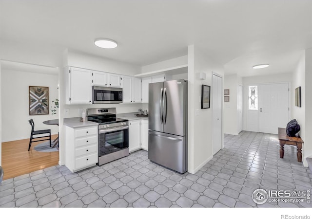 2036 Lexington Ct, Fort Collins, CO 80526 - kitchen with appliances with stainless steel finishes, light countertops, and white cabinetry