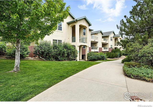 530 Mohawk Dr Unit 73, Boulder, CO 80303 - view of property with stucco siding and a front lawn