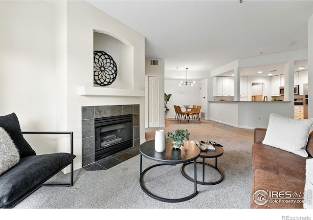 530 Mohawk Dr Unit 73, Boulder, CO 80303 - carpeted living area featuring a fireplace and a chandelier