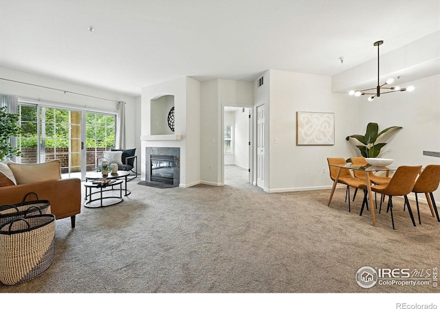 530 Mohawk Dr Unit 73, Boulder, CO 80303 - carpeted living area featuring a fireplace with flush hearth and a chandelier