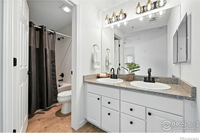 530 Mohawk Dr Unit 73, Boulder, CO 80303 - bathroom with double vanity, wood finished floors, and shower / bathtub combination with curtain