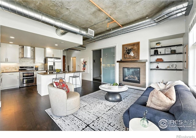 3401 Arapahoe Ave Unit 420, Boulder, CO 80303 - living room with dark wood-type flooring, a towering ceiling, and a glass covered fireplace