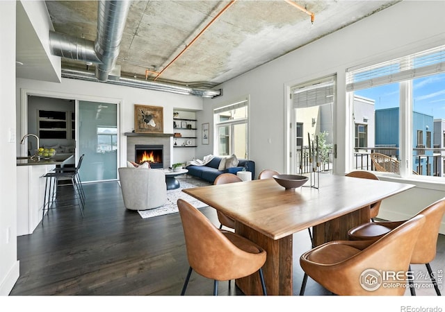 3401 Arapahoe Ave Unit 420, Boulder, CO 80303 - dining room featuring dark wood-style floors and a lit fireplace