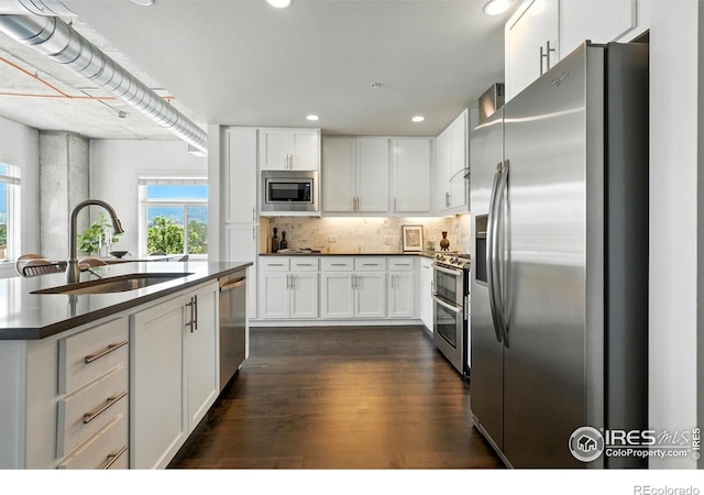 3401 Arapahoe Ave Unit 420, Boulder, CO 80303 - kitchen with appliances with stainless steel finishes, dark wood-style flooring, white cabinetry, and recessed lighting