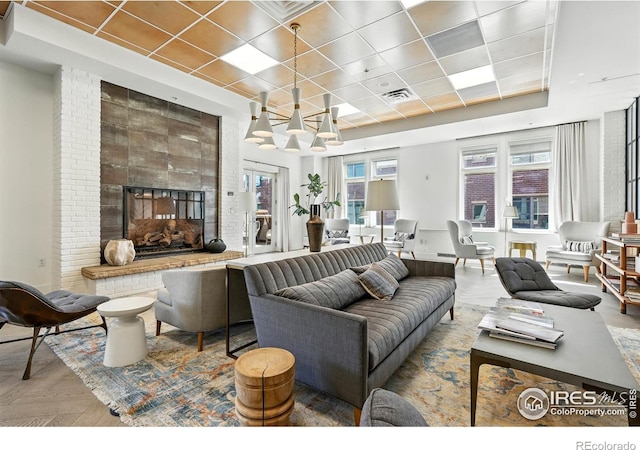3401 Arapahoe Ave Unit 420, Boulder, CO 80303 - living area with a raised ceiling, a fireplace, a chandelier, a drop ceiling, and wood finished floors