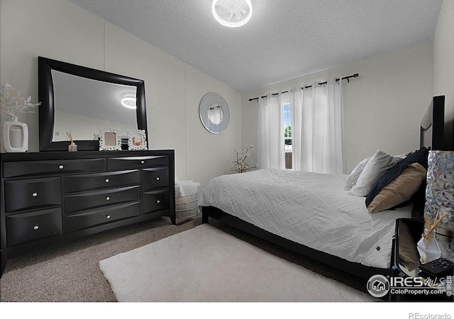 2036 1st Ave Unit 437, Greeley, CO 80631 - bedroom with carpet floors, a textured ceiling, and vaulted ceiling