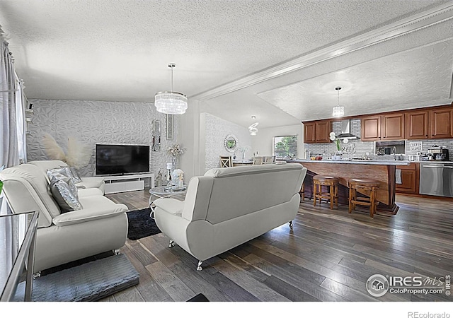 2036 1st Ave Unit 437, Greeley, CO 80631 - living room with a textured ceiling, dark wood-type flooring, lofted ceiling, and wallpapered walls