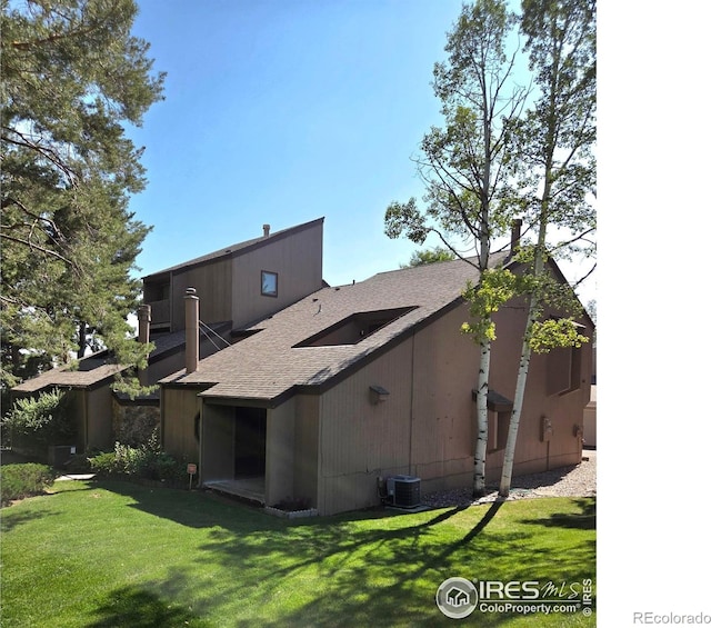 1550 W 28th St Unit 1, Loveland, CO 80538 - back of property with a shingled roof and a lawn